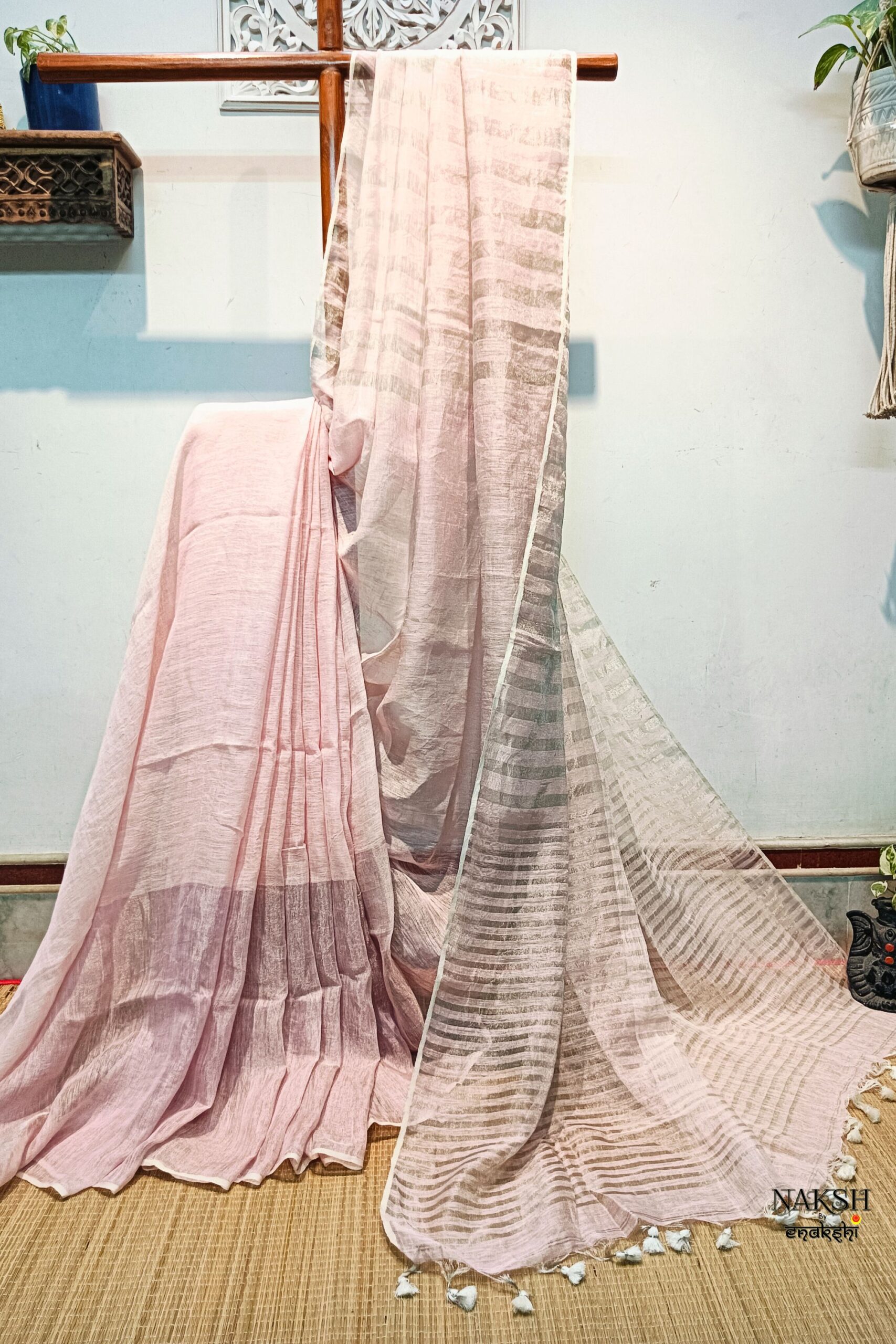 Organic tissue linen saree with blouse piece. Step into elegance with our sophisticated tissue linen sarees, adorned in classy pastel shades that exude timeless charm. Crafted with airy, breathable linen, these sarees ensure comfort while making a striking statement with their unique silver zari stripes. Perfect for any occasion, from casual gatherings to formal events, these sarees are versatile and effortlessly stylish. Each saree comes with a matching blouse piece, completing the ensemble with grace and finesse. Elevate your wardrobe with these exquisite pieces that blend luxury with comfort seamlessly.