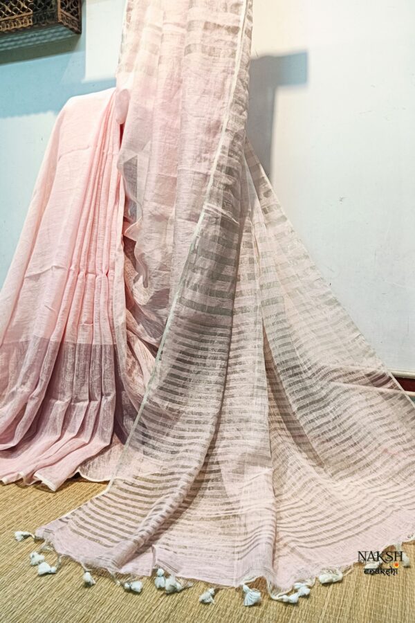 Step into elegance with our sophisticated tissue linen sarees, adorned in classy pastel shades that exude timeless charm. Crafted with airy, breathable linen, these sarees ensure comfort while making a striking statement with their unique silver zari stripes. Perfect for any occasion, from casual gatherings to formal events, these sarees are versatile and effortlessly stylish. Each saree comes with a matching blouse piece, completing the ensemble with grace and finesse. Elevate your wardrobe with these exquisite pieces that blend luxury with comfort seamlessly.