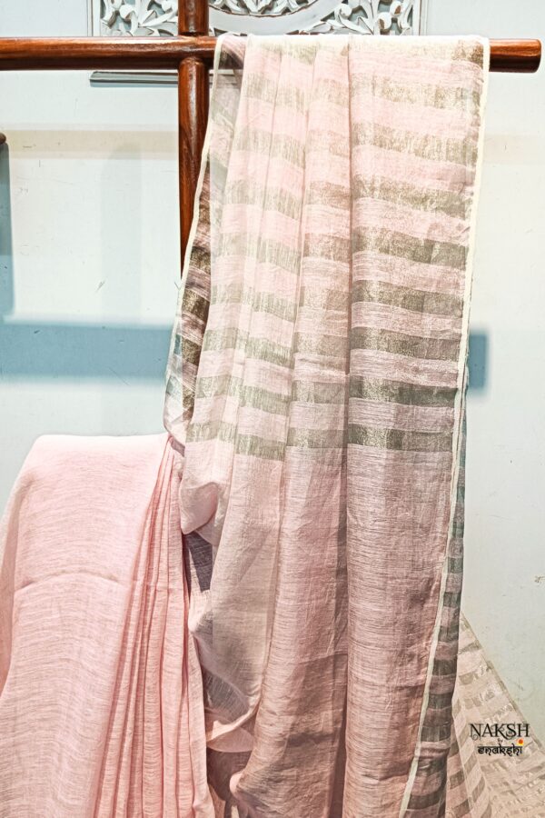 Step into elegance with our sophisticated tissue linen sarees, adorned in classy pastel shades that exude timeless charm. Crafted with airy, breathable linen, these sarees ensure comfort while making a striking statement with their unique silver zari stripes. Perfect for any occasion, from casual gatherings to formal events, these sarees are versatile and effortlessly stylish. Each saree comes with a matching blouse piece, completing the ensemble with grace and finesse. Elevate your wardrobe with these exquisite pieces that blend luxury with comfort seamlessly.