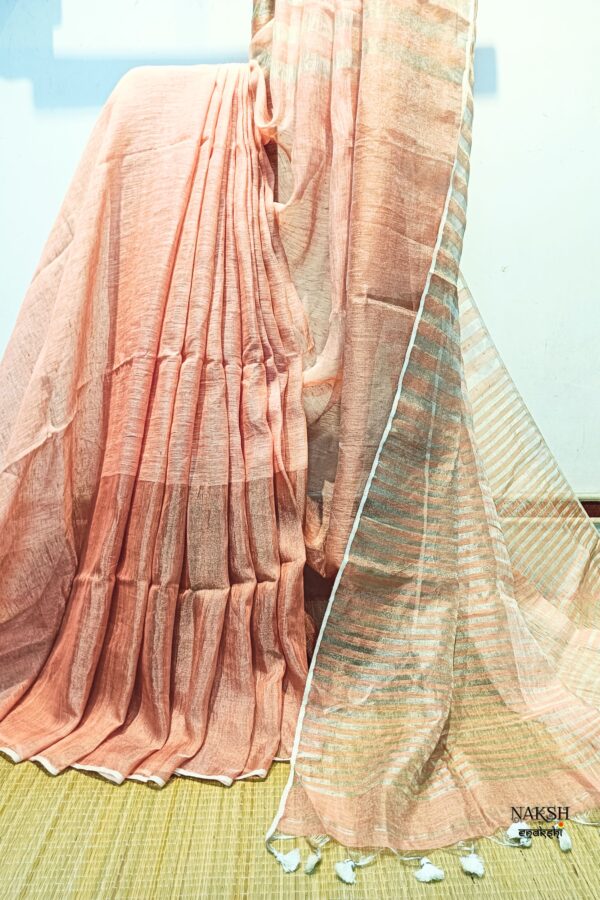 Organic linen saree with blouse piece.Step into elegance with our sophisticated tissue linen sarees, adorned in classy pastel shade of peach that exude timeless charm. Crafted with airy, breathable linen, this sareea ensure comfort while making a striking statement with their unique silver zari stripes. Perfect for any occasion, from casual gatherings to formal events, these sarees are versatile and effortlessly stylish. this saree comes with a running blouse piece, completing the ensemble with grace and finesse. Elevate your wardrobe with these exquisite pieces that blend luxury with comfort seamlessly.