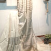zari stripes white or off white linen saree organic linen saree with blouse piece. Step into elegance with our sophisticated tissue linen sarees, adorned in refreshing pastel shade of mint green that exude timeless charm. Crafted with airy, breathable linen, this saree ensure comfort while making a striking statement with their unique silver zari stripes. Perfect for any occasion, from casual gatherings to formal events, these sarees are versatile and effortlessly stylish. this saree comes with a running blouse piece, completing the ensemble with grace and finesse. Elevate your wardrobe with these exquisite pieces that blend luxury with comfort seamlessly.