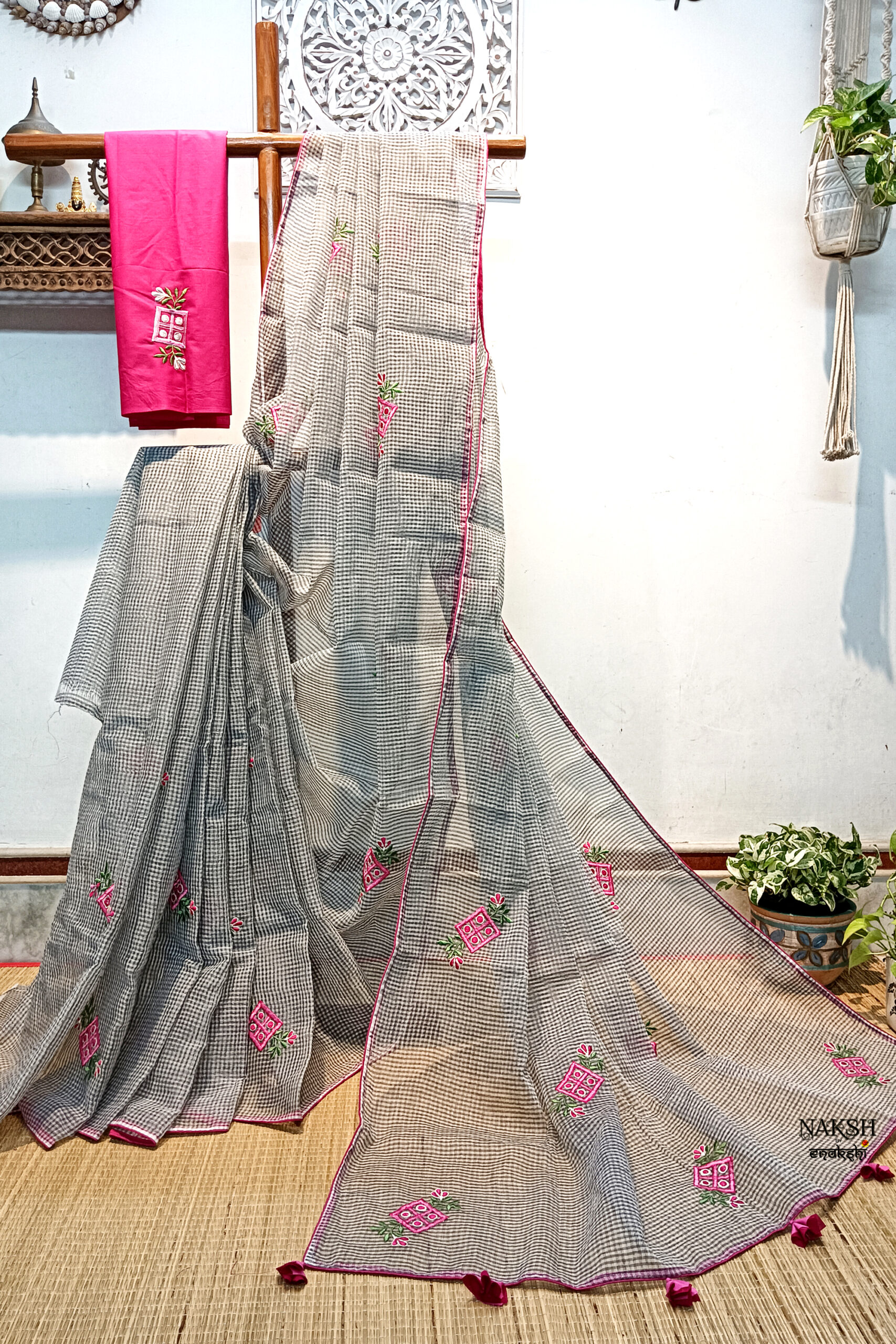 Handloom resham by cotton checks saree with embroidery work on grey color. A small and pretty floral motif has been neatly embroidered