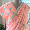 Peach pure cotton handloom saree with teal floral embroidery motifs gold scallop border and matching peach blouse piece with teal embroidery on mannequin by Naksh by Enakshi