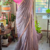 Smoky mauve pure cotton handloom saree with multicolor embroidery motifs gold pink scallop border and contrast bubblegum pink embroidered blouse piece displayed on mannequin by Naksh by Enakshi
