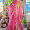 Full length rose petal dusty pink pure cotton handloom saree with all over gold embroidery motifs gold scallop border contrast lime green blouse and pink tassels displayed on mannequin by Naksh by Enakshi